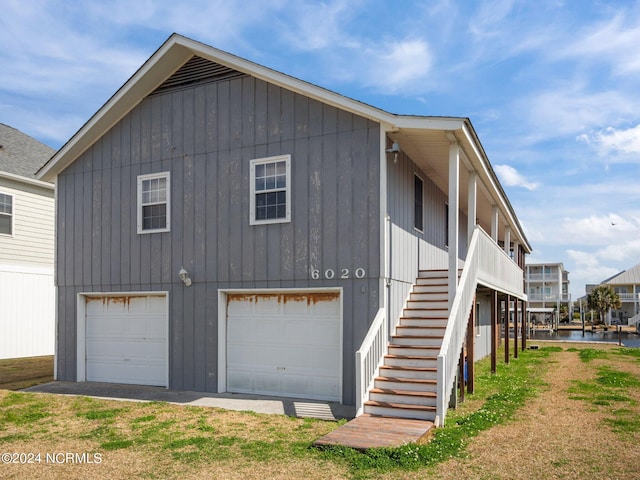 view of home's exterior featuring a water view and a garage