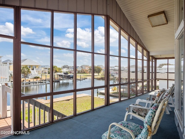 sunroom / solarium with a healthy amount of sunlight and a water view