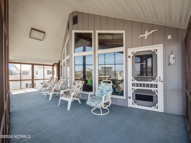 unfurnished sunroom featuring lofted ceiling