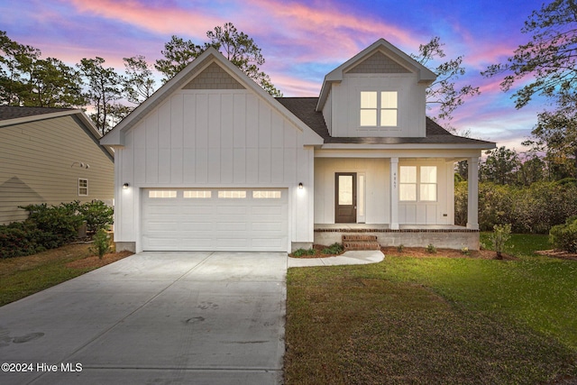 4865 Scarlet Sage Way, Shallotte, NC 28470 - modern inspired farmhouse with a garage, a front yard, covered porch, concrete driveway, and board and batten siding