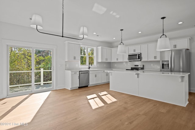 4865 Scarlet Sage Way, Shallotte, NC 28470 - kitchen with stainless steel appliances, light countertops, light wood-type flooring, tasteful backsplash, and recessed lighting