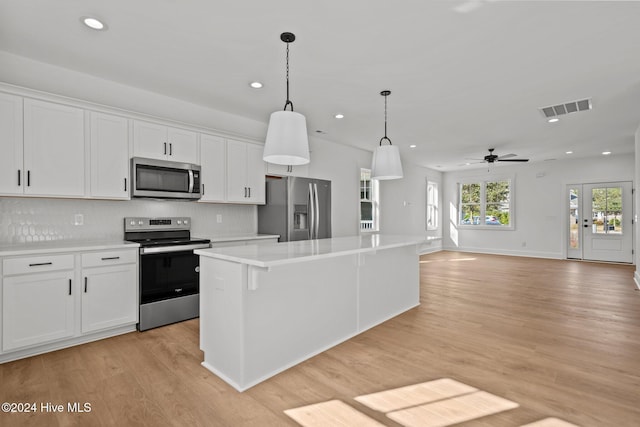 4865 Scarlet Sage Way, Shallotte, NC 28470 - kitchen featuring stainless steel appliances, recessed lighting, light countertops, white cabinets, and light wood-style floors
