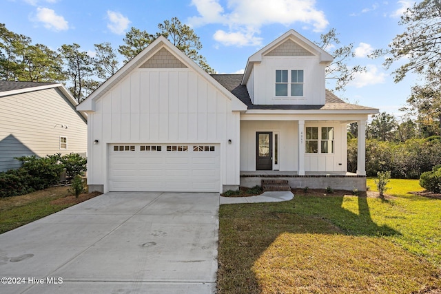 4865 Scarlet Sage Way, Shallotte, NC 28470 - modern farmhouse style home featuring board and batten siding, an attached garage, roof with shingles, and a front lawn