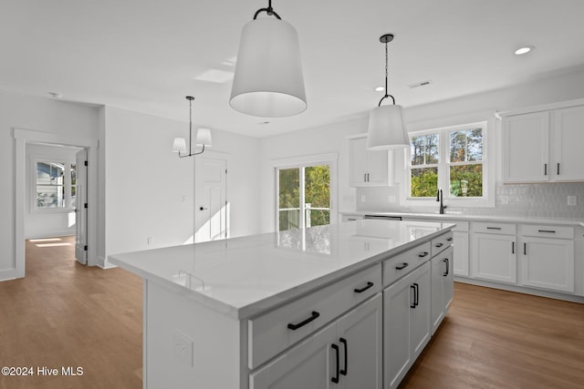 4865 Scarlet Sage Way, Shallotte, NC 28470 - kitchen featuring backsplash, light wood-type flooring, a kitchen island, white cabinets, and recessed lighting