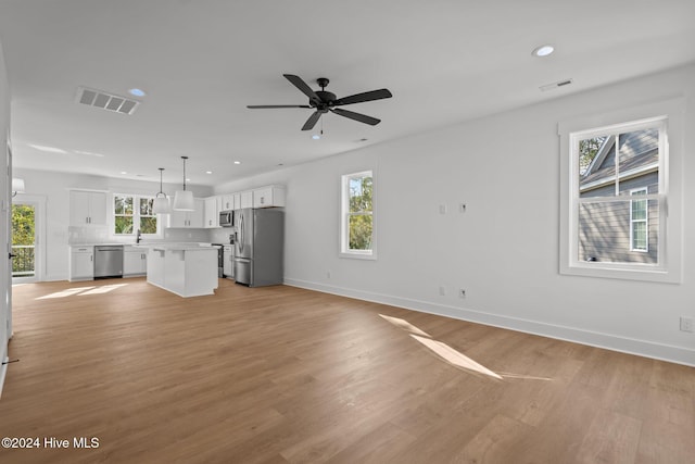 4865 Scarlet Sage Way, Shallotte, NC 28470 - unfurnished living room with recessed lighting, light wood-style floors, and ceiling fan
