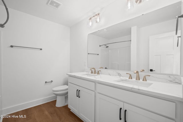4865 Scarlet Sage Way, Shallotte, NC 28470 - bathroom with double vanity, wood finished floors, and a shower