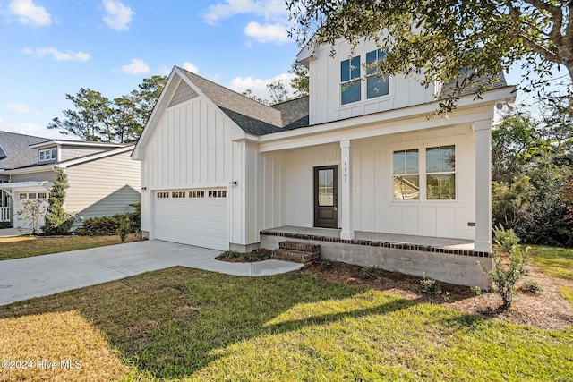 4865 Scarlet Sage Way, Shallotte, NC 28470 - view of front of property with board and batten siding, a porch, driveway, and a shingled roof