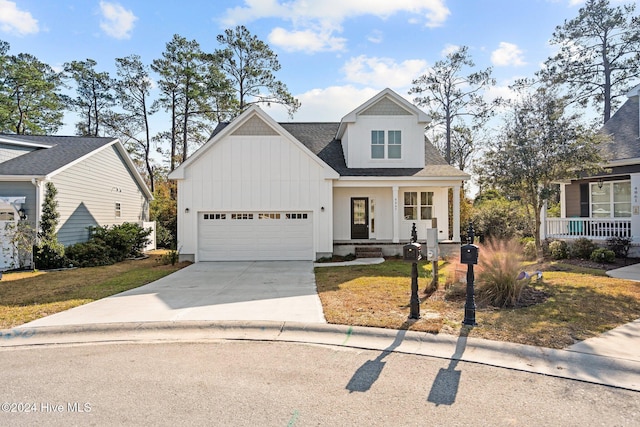 4865 Scarlet Sage Way, Shallotte, NC 28470 - modern inspired farmhouse featuring board and batten siding, concrete driveway, a porch, an attached garage, and a shingled roof
