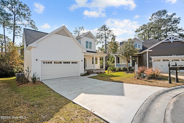 4865 Scarlet Sage Way, Shallotte, NC 28470 - view of front of house with covered porch, board and batten siding, a garage, and driveway
