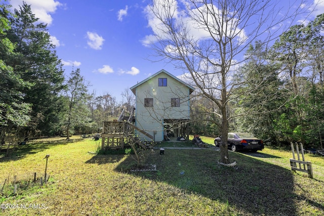 view of property exterior featuring a deck and a lawn