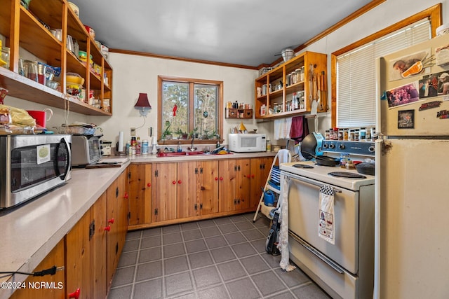 kitchen featuring white appliances, ornamental molding, light tile floors, and sink