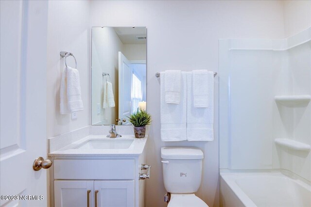 bathroom with toilet, visible vents, and vanity