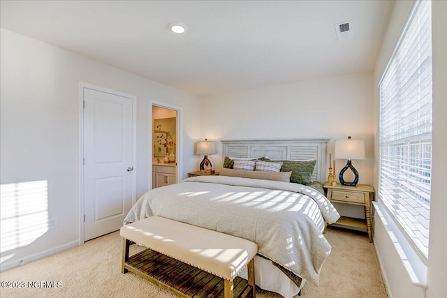 bedroom featuring light carpet, baseboards, and visible vents