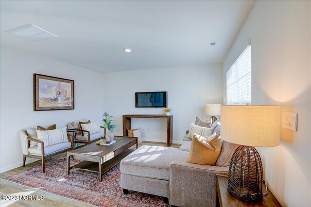 living room with recessed lighting and baseboards