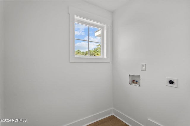 clothes washing area with washer hookup, dark wood finished floors, electric dryer hookup, laundry area, and baseboards