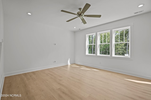 spare room with recessed lighting, light wood-type flooring, visible vents, and baseboards