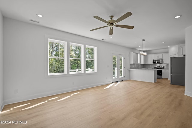 unfurnished living room featuring light wood-type flooring, visible vents, baseboards, and recessed lighting