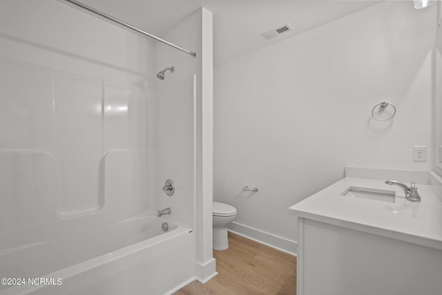 full bath featuring shower / bathtub combination, toilet, wood finished floors, visible vents, and baseboards