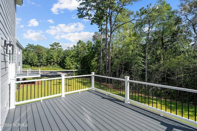 wooden terrace featuring a yard