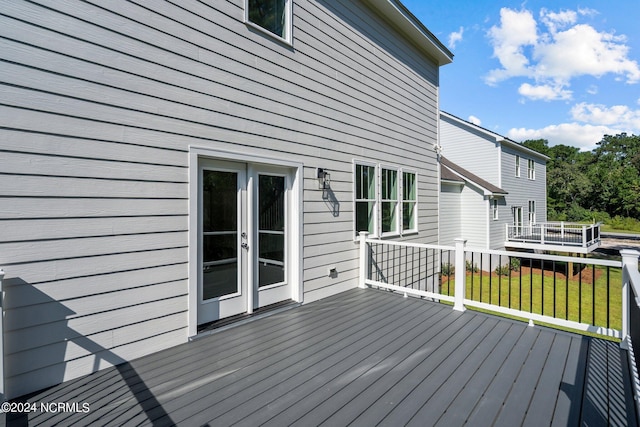 wooden deck featuring a yard