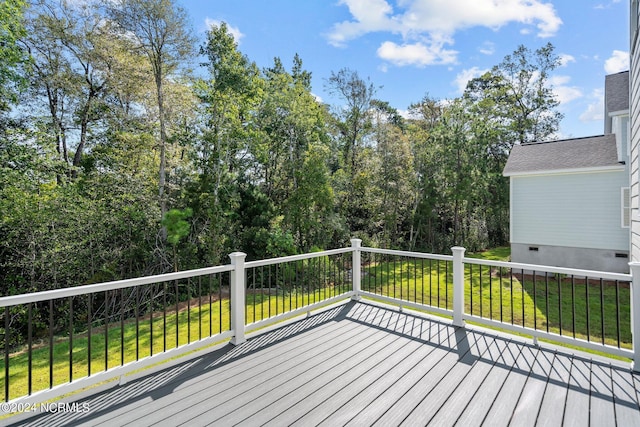 wooden terrace with a lawn