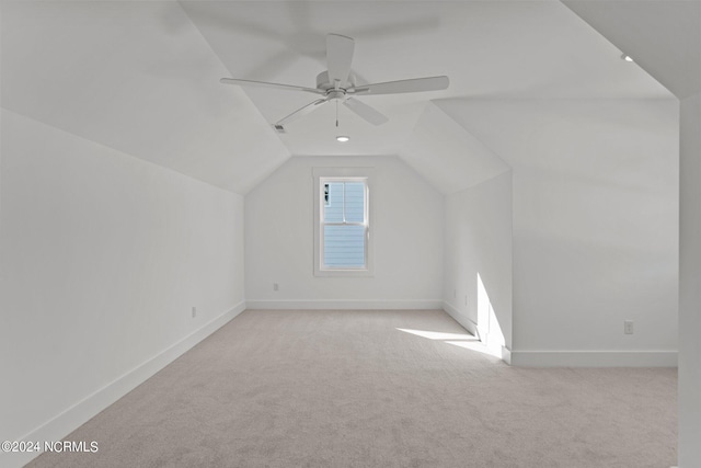 additional living space with carpet flooring, vaulted ceiling, and baseboards