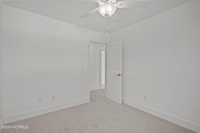 spare room featuring ceiling fan, baseboards, and carpet flooring