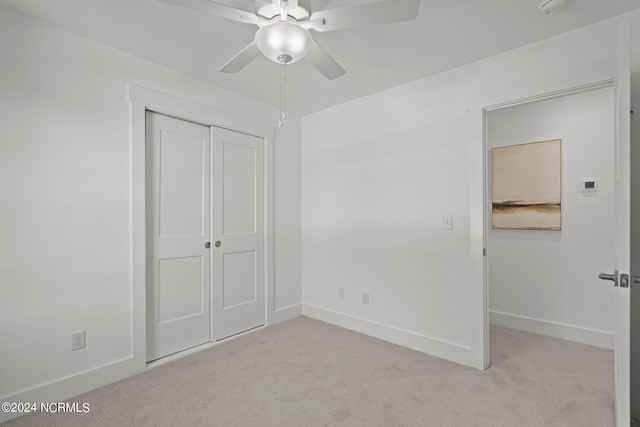 unfurnished bedroom featuring carpet floors, a ceiling fan, baseboards, and a closet