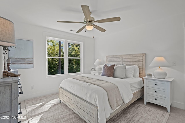 bedroom featuring carpet, ceiling fan, visible vents, and baseboards