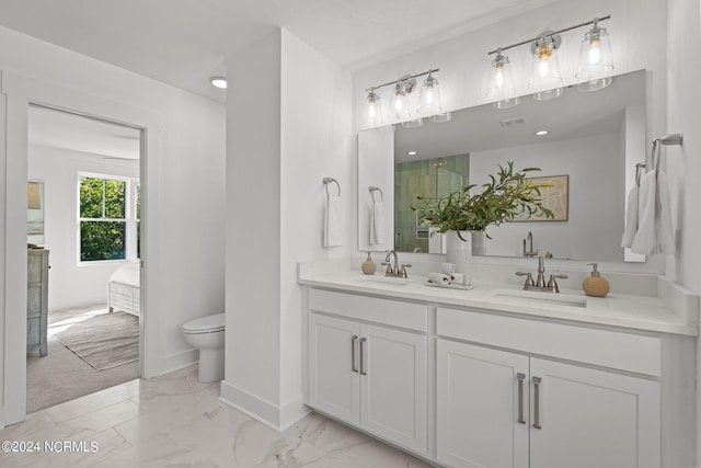 full bath featuring marble finish floor, double vanity, a sink, and connected bathroom