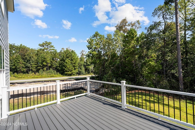 wooden terrace with a lawn