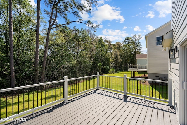 wooden terrace featuring a lawn