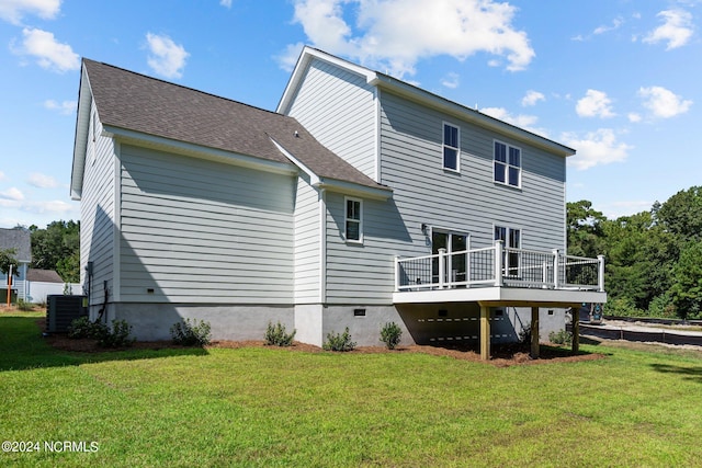 rear view of property featuring a deck, central AC, a yard, and roof with shingles