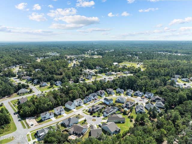 birds eye view of property featuring a forest view and a residential view