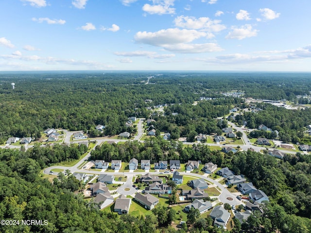 birds eye view of property with a wooded view and a residential view