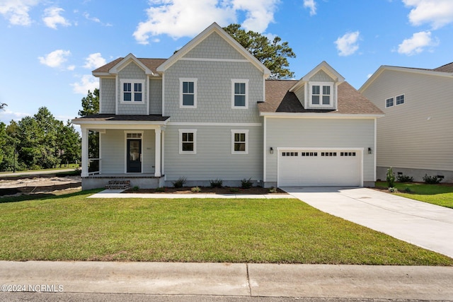 view of front of house with a garage, a shingled roof, concrete driveway, covered porch, and a front lawn