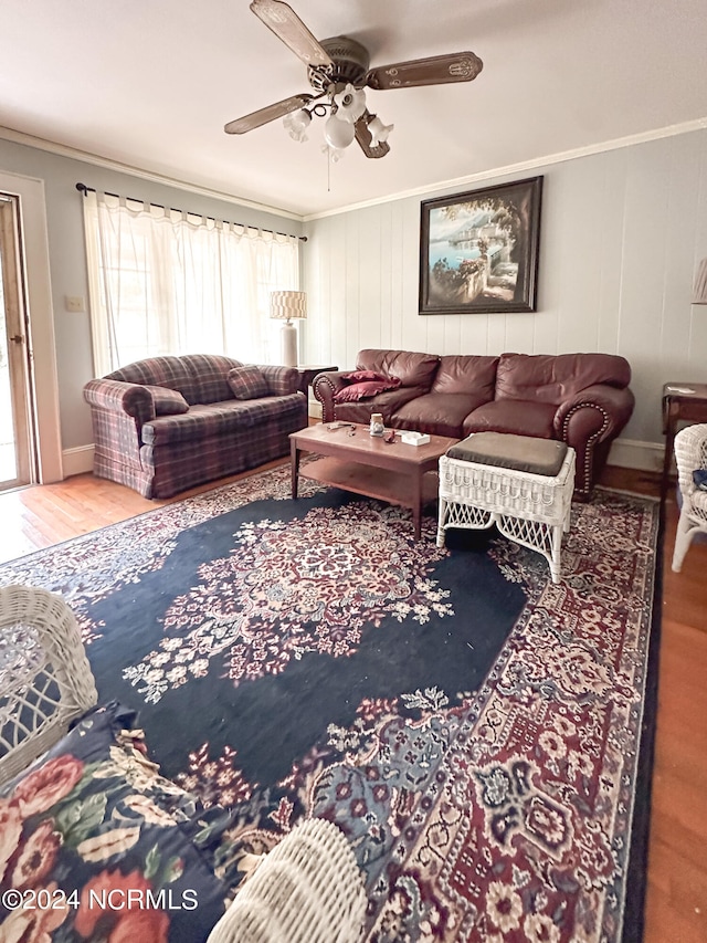 living room featuring ceiling fan, hardwood / wood-style flooring, and ornamental molding