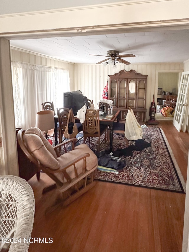 living room featuring ceiling fan, dark hardwood / wood-style flooring, and ornamental molding