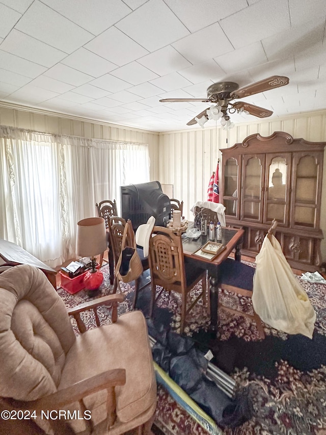 interior space featuring ornamental molding and ceiling fan