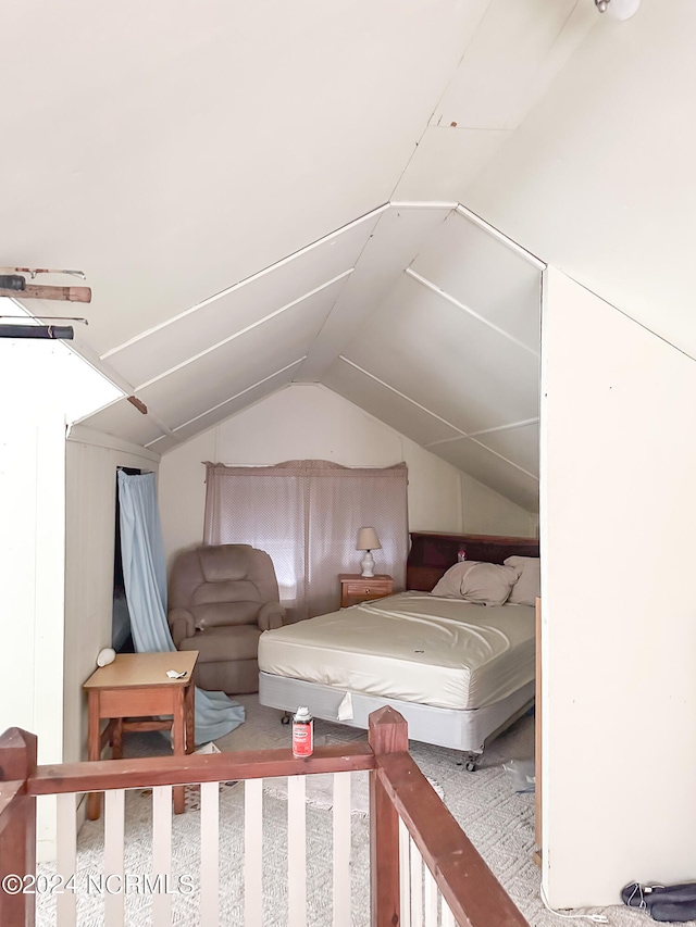 carpeted bedroom featuring lofted ceiling