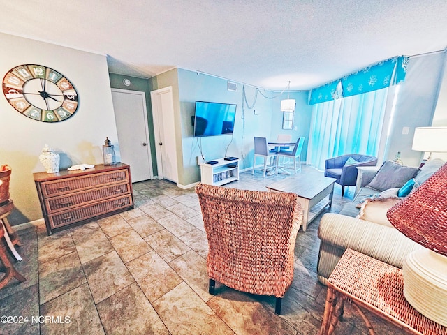 living room with light tile floors and a textured ceiling