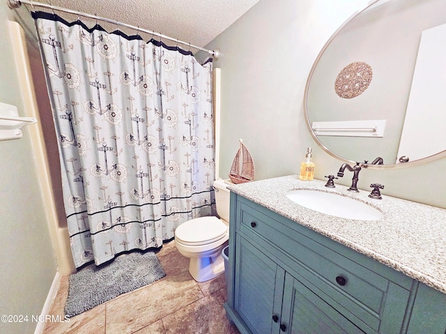 bathroom featuring tile floors, toilet, a textured ceiling, and vanity