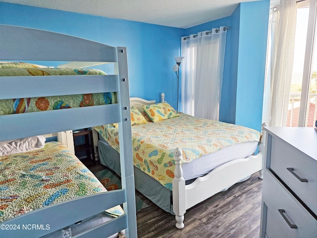 bedroom featuring a textured ceiling and dark wood-type flooring