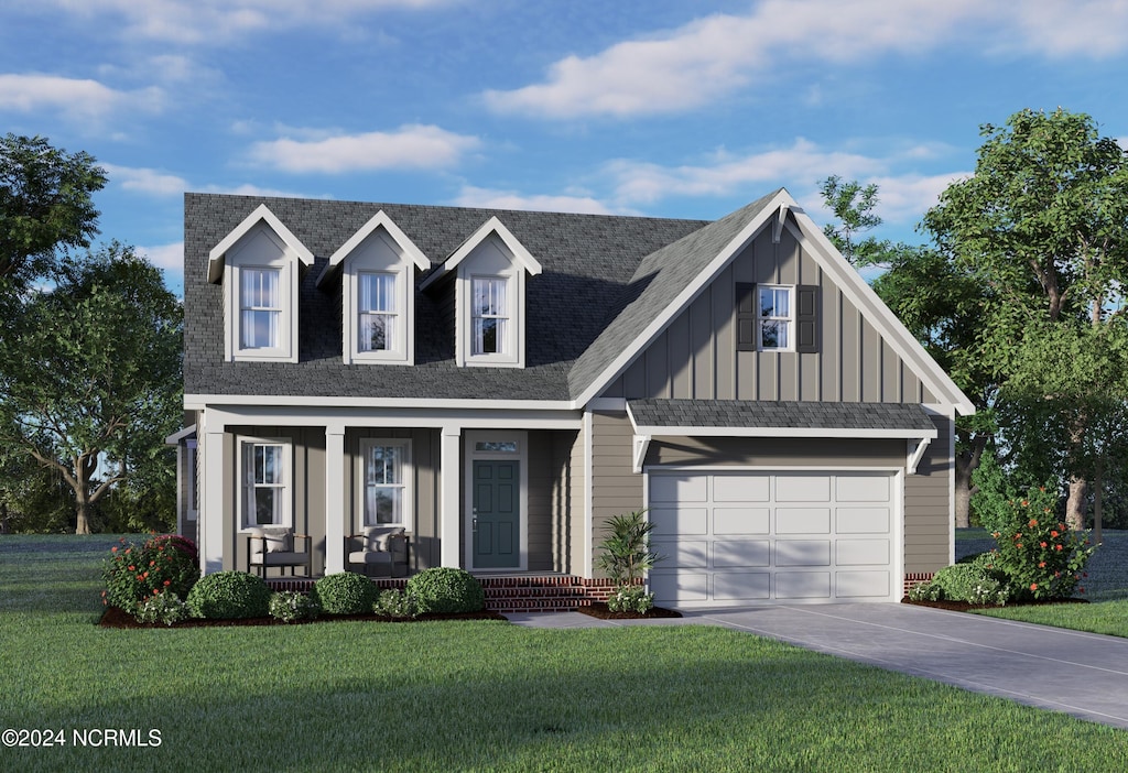 view of front of property with covered porch, a front lawn, and a garage