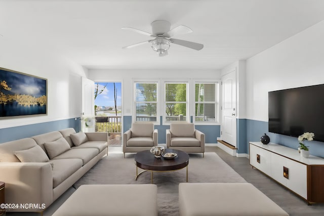 living room with ceiling fan and wood finished floors