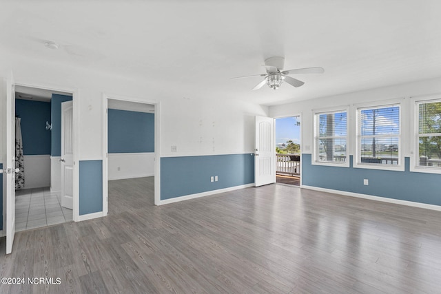 unfurnished living room featuring hardwood / wood-style flooring, ceiling fan, and a healthy amount of sunlight