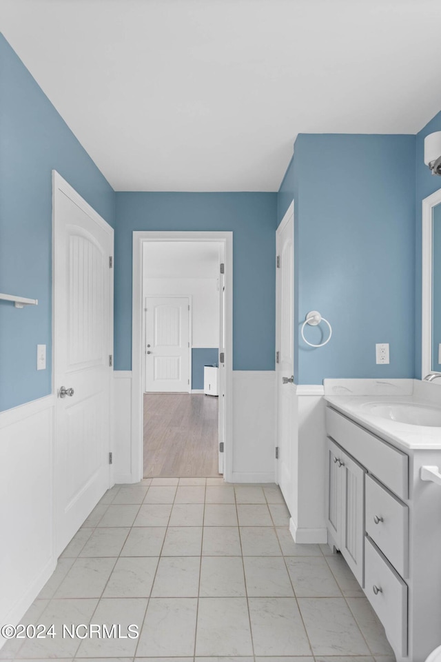 bathroom featuring wainscoting, tile patterned flooring, and vanity