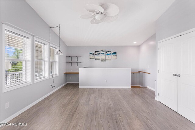 unfurnished room with light wood-type flooring, ceiling fan, and lofted ceiling