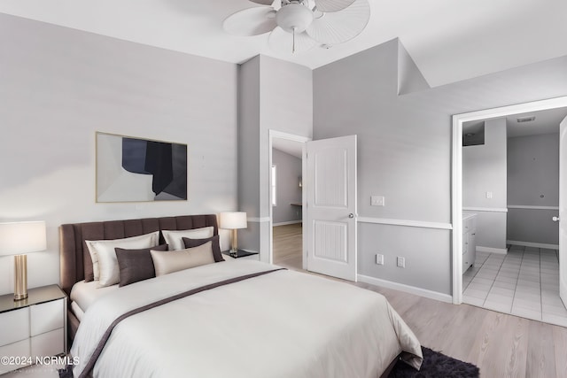 bedroom featuring light wood-style floors, baseboards, and a ceiling fan