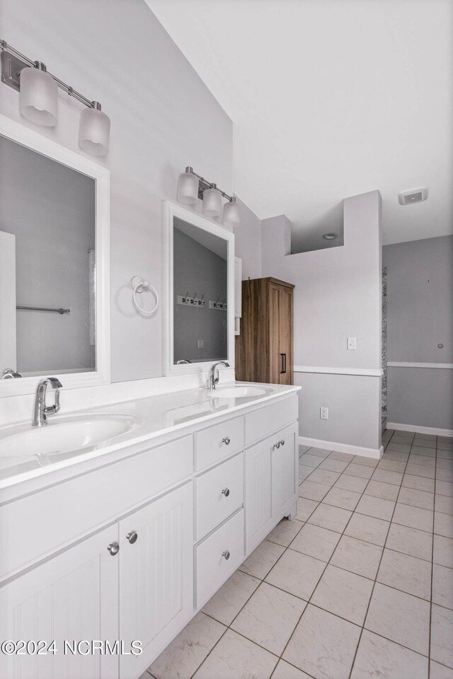 bathroom featuring tile patterned flooring and vanity